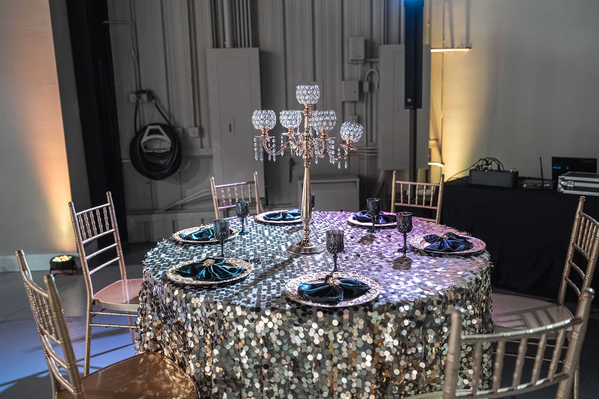 event table styled with silver sparkle tablecloth and lights