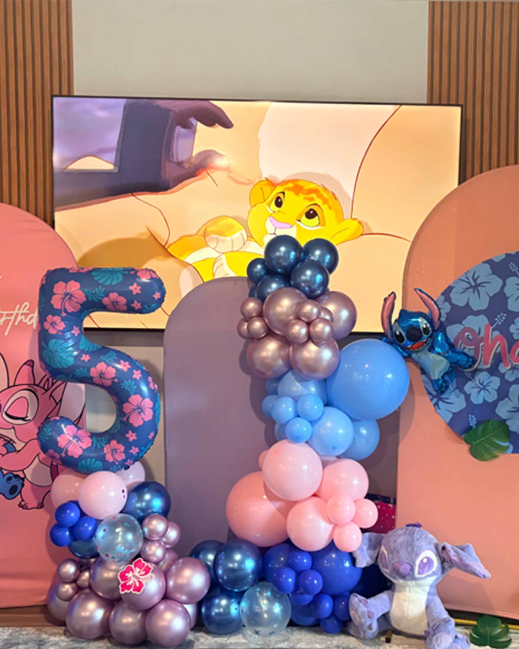 A lively birthday party atmosphere showcasing bright balloons and an adorable stuffed animal as decorations