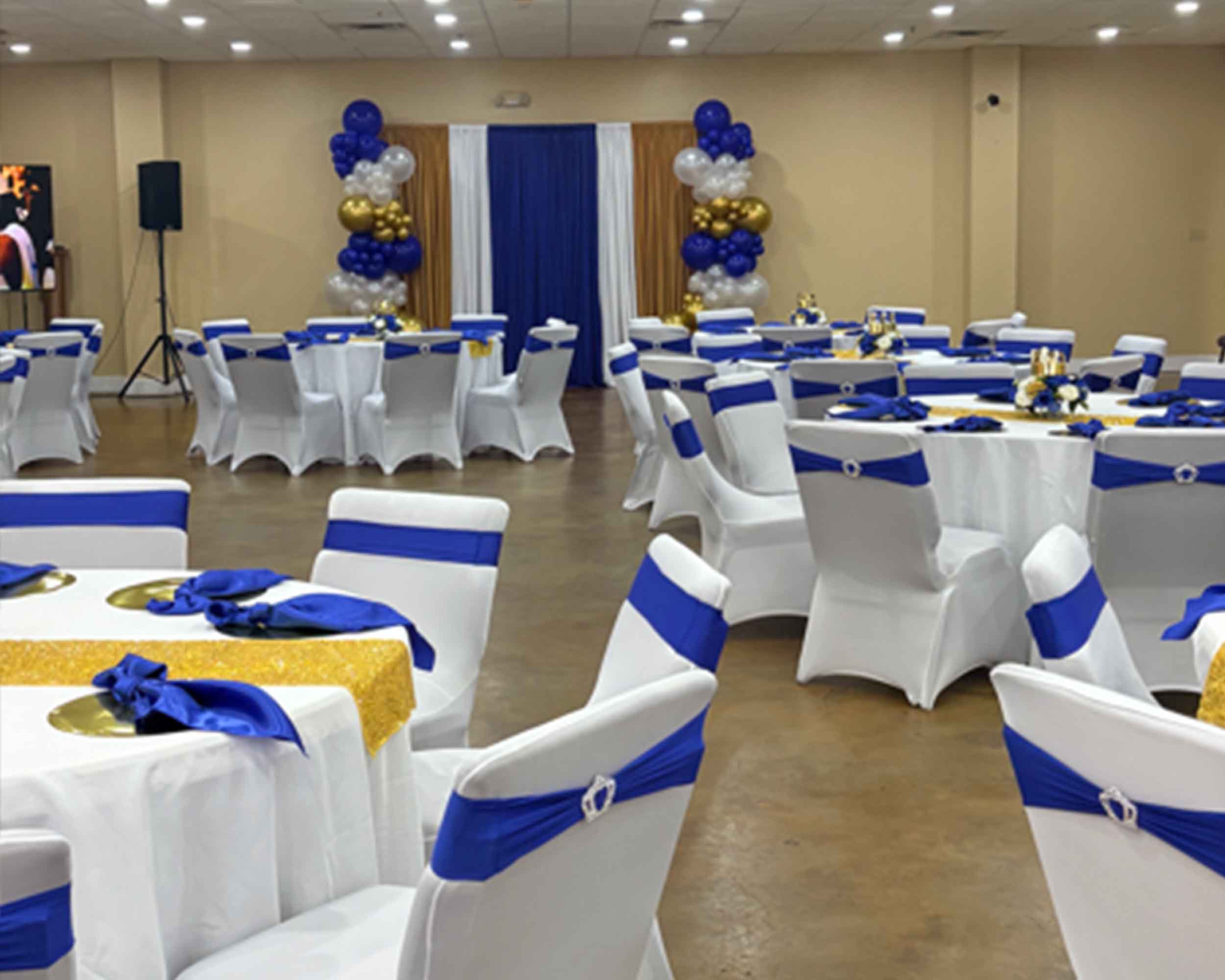 A banquet room adorned with elegant blue and white decorations, featuring tables set for a formal event